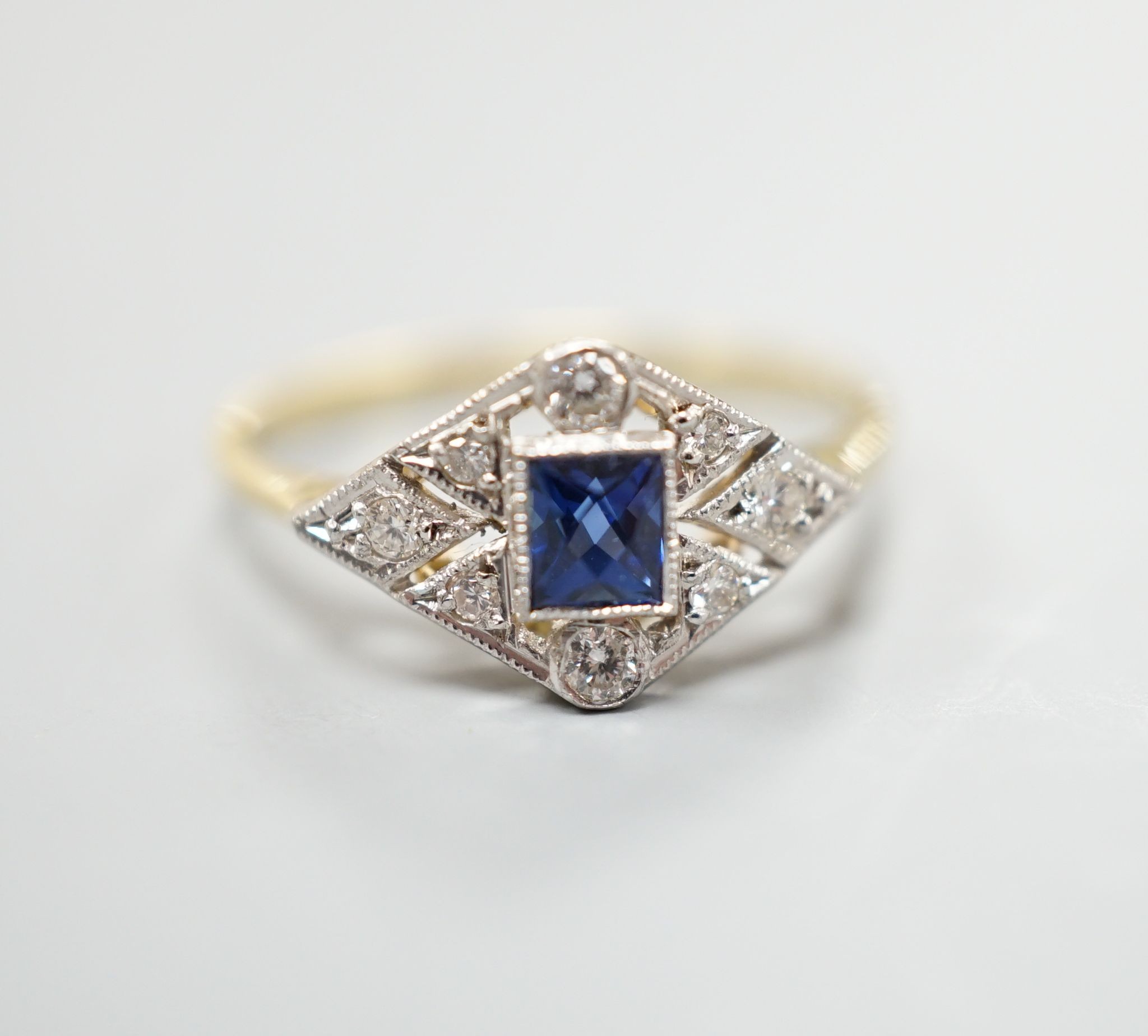 A 1920's 18ct, sapphire and diamond set shaped cluster ring, size N, gross weight 2.5 grams.